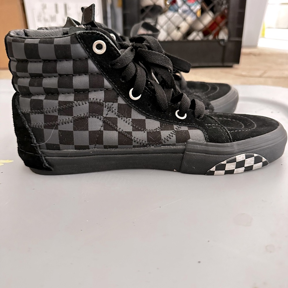 Checkered, zip up Vans.